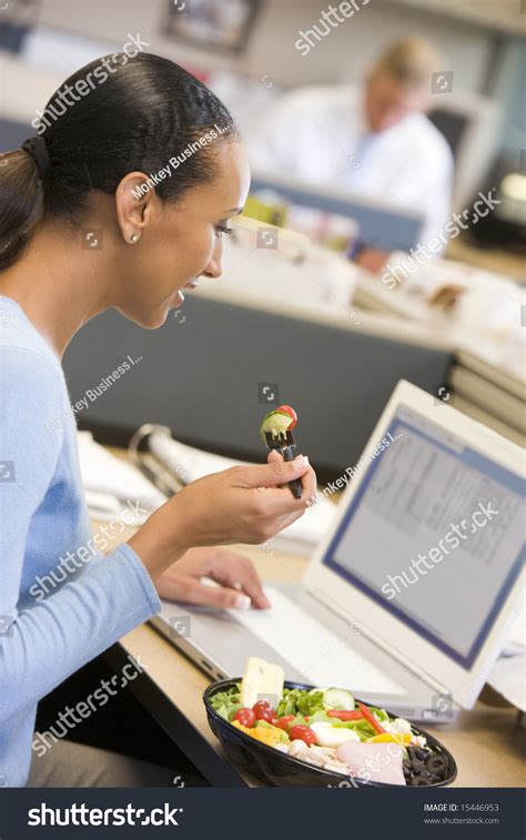 Businesswoman Cubicle Laptop Eating Salad Stock Photo 15446953