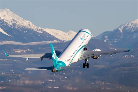 Air Dolomiti Aircraft Taking Off At Verona Airport With Monti Lessini