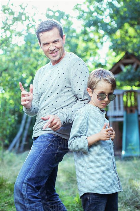 Father And Son Gesturing Outdoors Stock Photo Dissolve