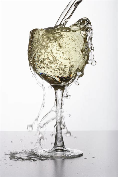 White Wine Overflowing From Glass By Paul Taylor