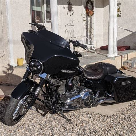 A Black Motorcycle Parked In Front Of A House