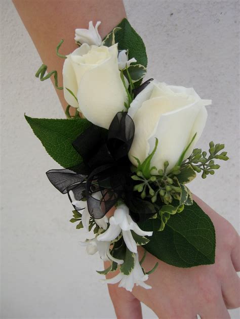 Wrist corsage with white spray roses, orchids and alstromeria on a cage of hot pink / orange striped ribbon with rhinestone spray accents. two white rose corsage | More Images at www ...