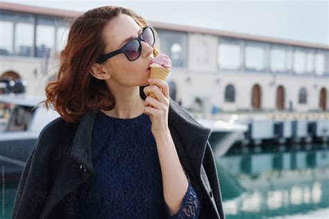 Beautiful Woman Eating Ice Cream Outdoors By Stocksy Contributor