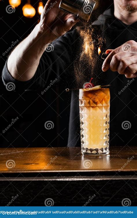 Burning Cinnamon In Cocktail Bartender Pours And Fire Burns Cinnamon In Alcoholic Cocktail At A