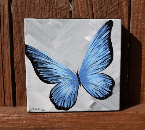 A Painting Of A Blue Butterfly On A Wooden Fence