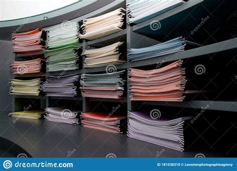 Office Shelves Stacked With Multi Coloured Folders And Documents Stock