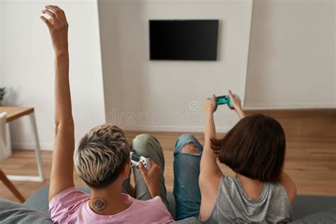 Back View Of Lesbian Girls Play Video Game On Sofa Stock Image Image Of Couple Activity