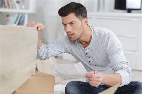 Man Assembling Shelf At Home Stock Image Image Of Puzzled