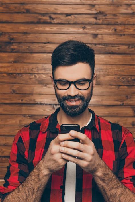 Portrait Of Cheerful Smiling Young Man Chatting On Smartphone Stock