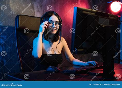 Portrait Shot Of A Smiling Beautiful Professional Gamer Girl Playing In First Person Shooter