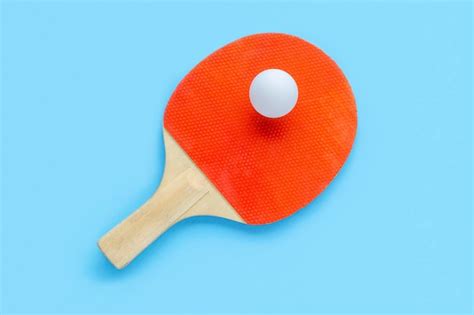 premium photo red racket for table tennis with white ball on blue background ping pong sports