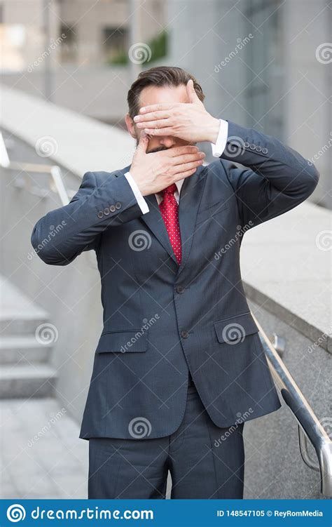 Calm Businessman With Hands Covering His Mouth And Eyes Stock Image