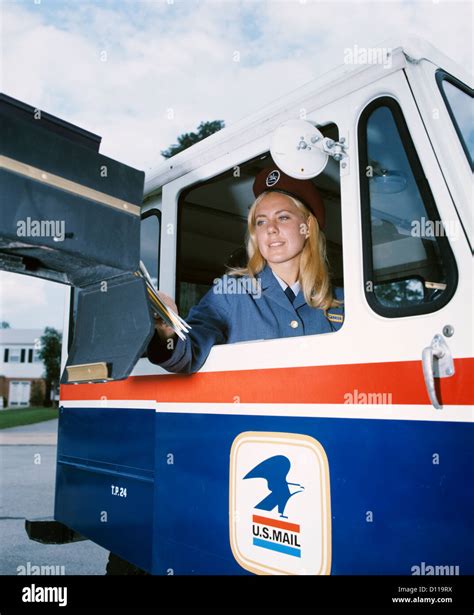 S Female Mail Carrier In U S Mail Truck Delivering Mail To Home Mailbox Stock Photo Alamy