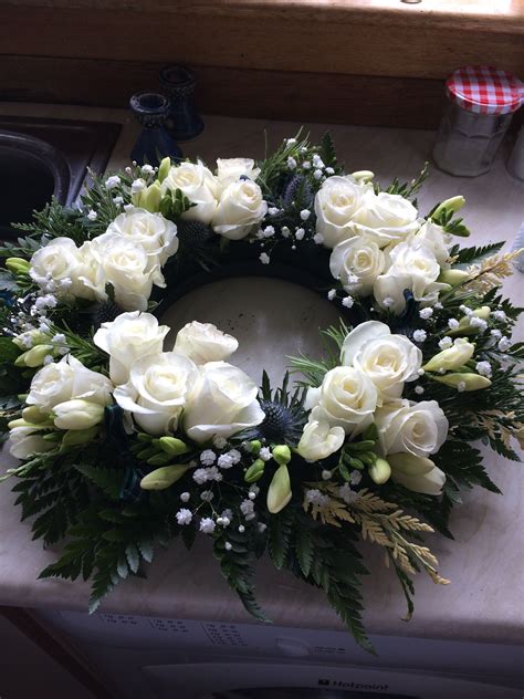Scottish funeral wreath with roses and freesia Arrangements Funéraires