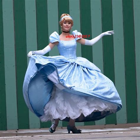 A Woman In A Blue And White Dress Is Dancing
