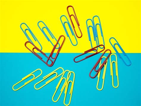 Premium Photo Colored Paper Clips On Paper Office Supplies Business Goods