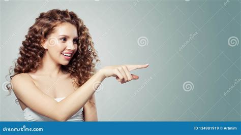 Pretty Woman Pointing And Showing Empty Copy Space Beautiful Girl With Long Curly Hair Pointing