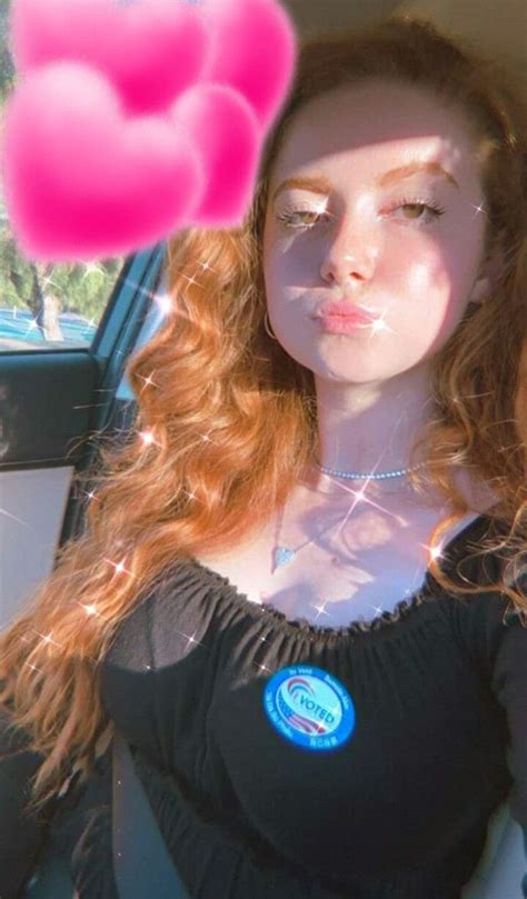 A Woman Sitting In The Back Seat Of A Car With Pink Balloons Floating