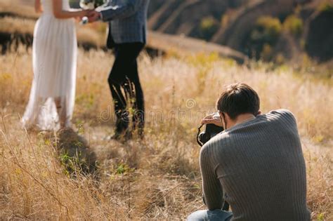 Wedding Photographer Takes Pictures Of The Bride And Groom Stock Image