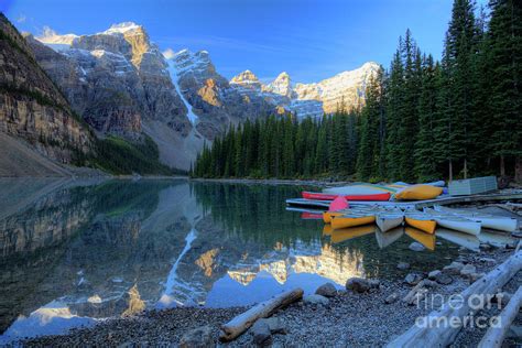 Moraine Lake Sunrise Blue Skies Canoes By Wayne Moran Royalty Free