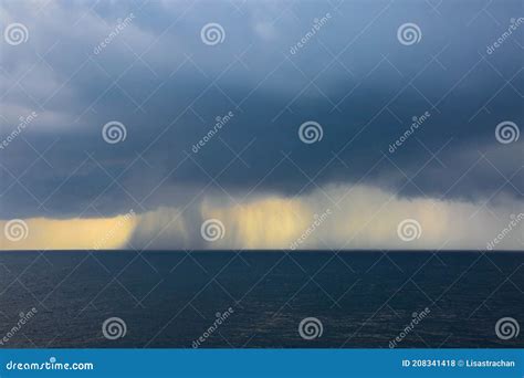 Rain And Storms Over The Ocean On A Grey Cloud Day At Sea Stock Photo