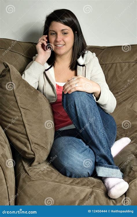 Girl Sitting On Couch Talking On Cell Phone Stock Photo Image Of