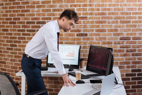 Young Businessman Sitting Near Computers Smartphone Stock Image