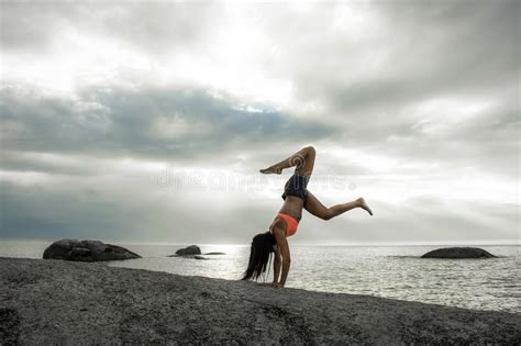 Woman Doing A Handstand On A Rock At Sunset On Bakovern Beach Cape Town Stock Photo Image Of