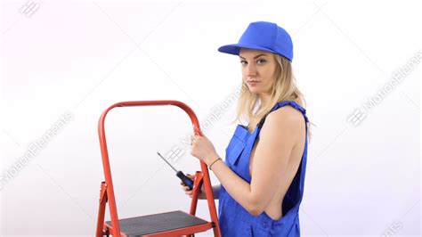 Naked Girl With Screwdriver In Blue Overalls Near Ladder At White