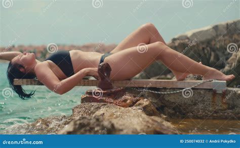 The Girl Sunbathes By The Sea On The Rocks Stock Footage Video Of