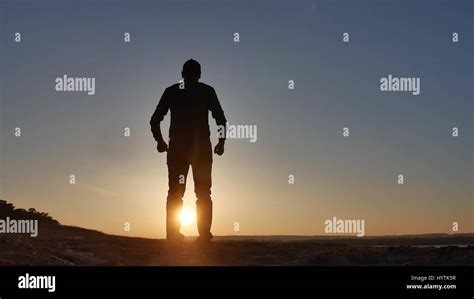 Freedom Man Stands On A Cliff Sunset Silhouette Hand Lifestyle In The