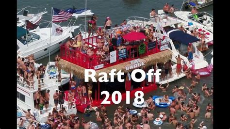 A Boat Full Of People On The Water With Words Raft Off Above It