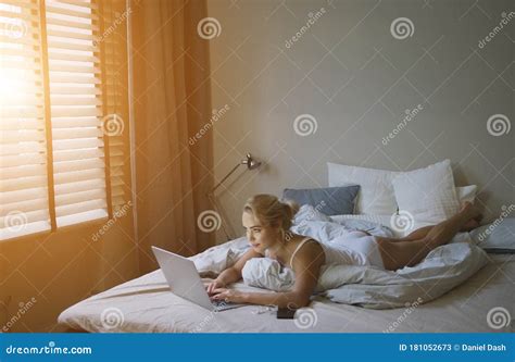 Sensual Young Woman In White Tank Top And Panties Lying On Bed Near Laptop Stock Image Image