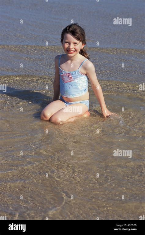 7 Year Old Girl Playing At Beach Stock Photo Alamy