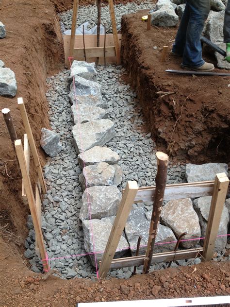 Building a stone wall is not difficult with expertise and tips. Building a Stone Foundation | This Cob House