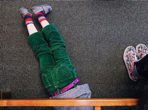 Childs Legs Sticking Out From Under Bench By Stocksy Contributor