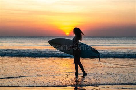 Portrait Of Woman Surfer With Beautiful Body On The Beach With Surfboard At Colorful Sunset In