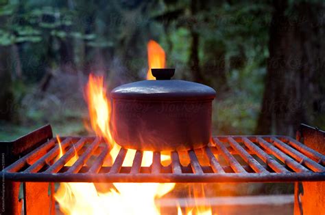 Cooking Over A Campfire By Stocksy Contributor Carleton Photography