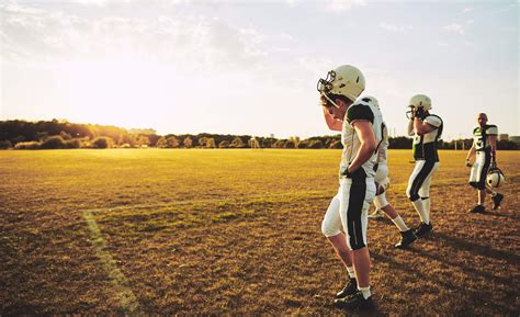 Young American Football Players Walking Off A Field After Practi Main