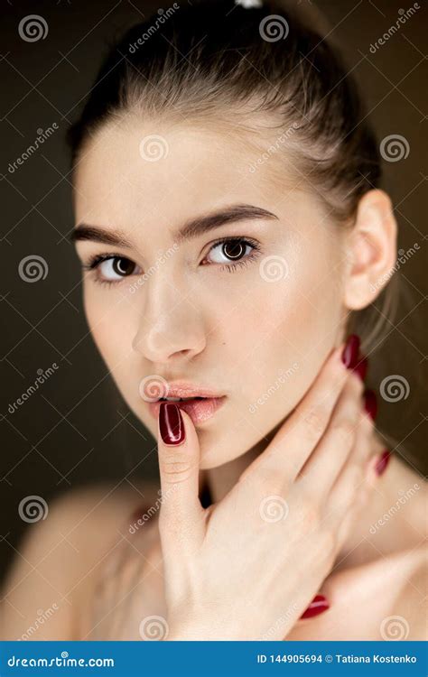 Portrait Of Young Charming Girl With Natural Makeup Holding Her Hands