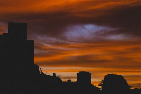 Dark City Buildings Under Colorful Cloudy Sky At Sundown · Free Stock Photo