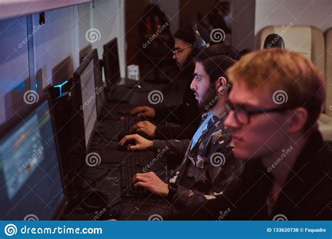 Team Of Teenage Gamers Plays In A Multiplayer Video Game On Pc In A