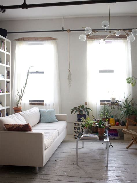 Brooklyn Loft Living Room With White Painted Floors White Couch And