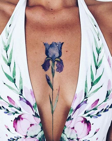 This pattern is inked in a strict manner with a lined design. Blue Tulip Sternum Tattoo | Amazing Tattoo Ideas
