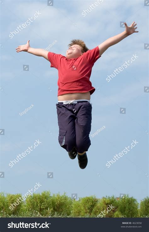 A Little Boy Jumps With Sky At Background Stock Photo 4623058