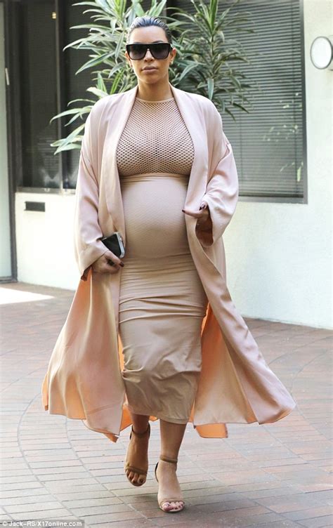 Kim Kardashian Shows Her Pregnant Figure In Skirt And Net Top Beneath A