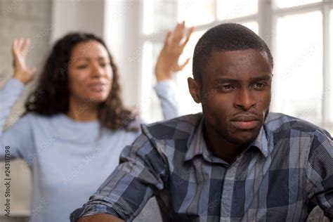 Thoughtful Upset African Husband Feels Disappointed In Love Ignoring Avoiding Angry Wife