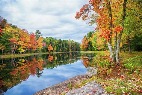 Fall Foliage Colors Reflected In Still Lake Water On A Beautiful