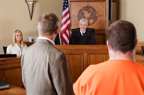 Accused Criminal And Lawyer In A Courtroom Stock Photo Download Image