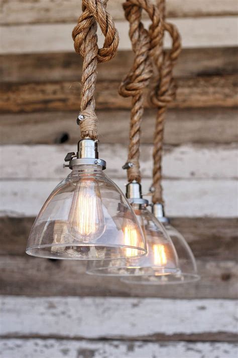 An Old Fashioned Light Fixture Hanging From A Wooden Ceiling With Rope
